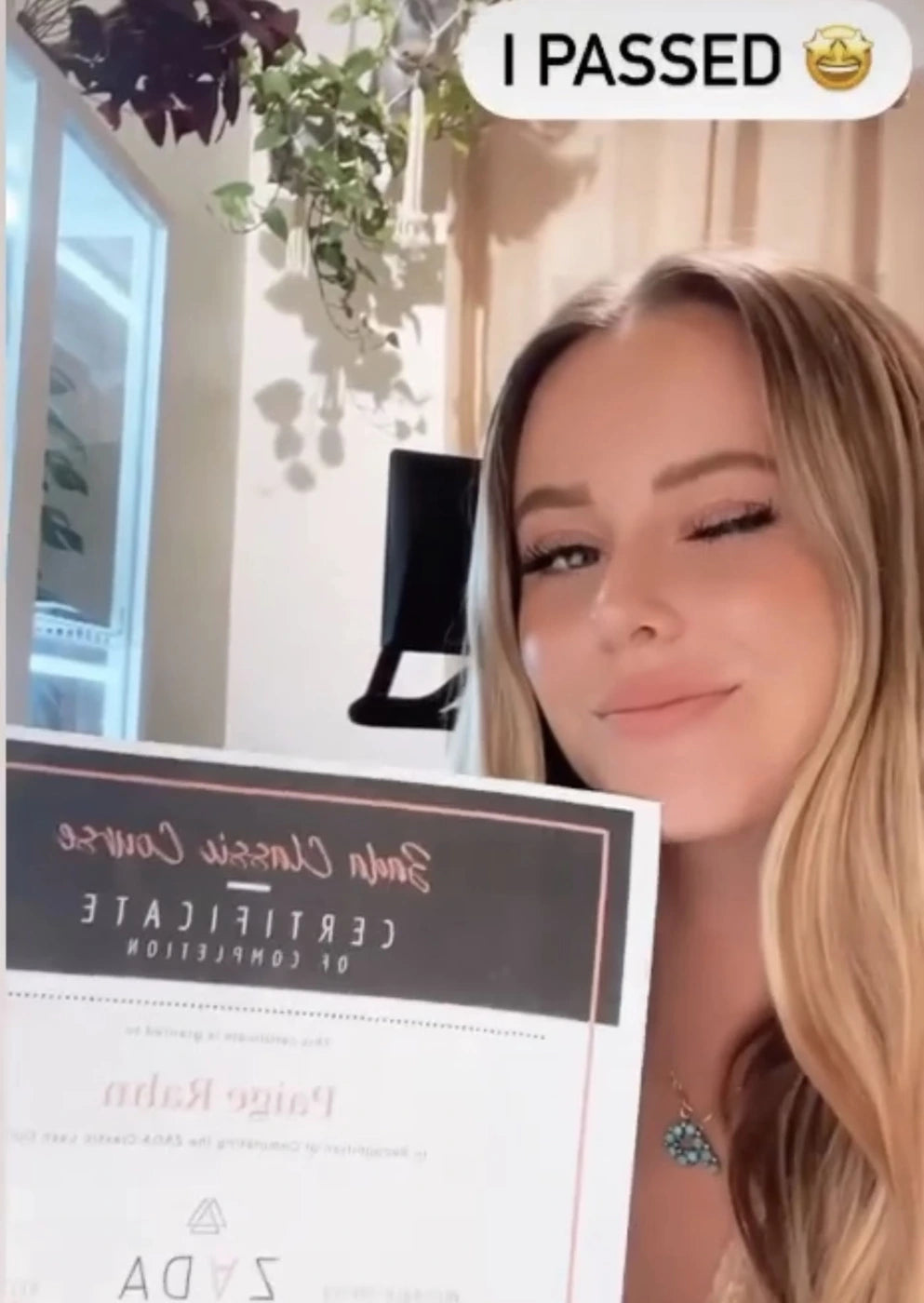 Zada student holding her course completion certificate